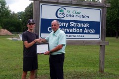 Tanner Grubb (left) is awarded with the Tony Stranak Conservation Scholarship by St. Clair Region Conservation Authority Chair, Greg Grimes (right).