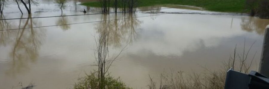 image of flooded table lands adjacent to a watercourse that has topped its banks due to extensive rain events