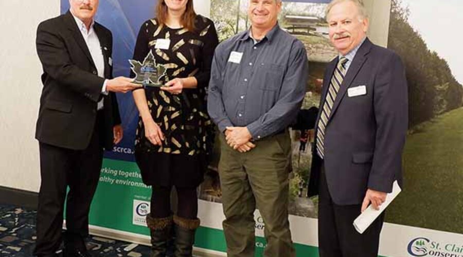 Pat Brown, Vivian Crump, Chris Crump, and Mike Stark stand in front of St. Clair Region Conservation Authority banners.