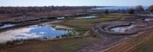 Aerial photo of newly constructed wetlands at the Keith McLean Conservation Lands with Lake Erie visible in the background.