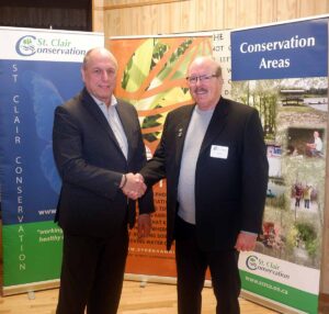 Two men standing and shaking hands