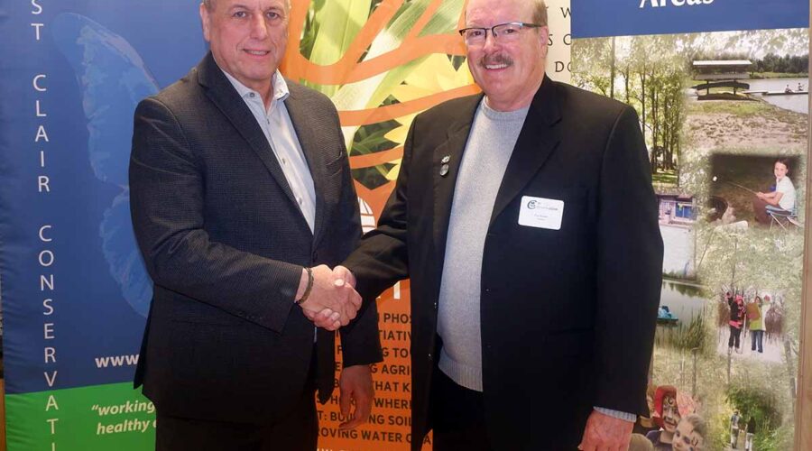 Two men standing and shaking hands