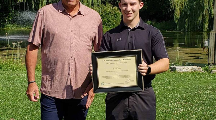 Tyson Lozon (right) is awarded with the A.W. Campbell Memorial Scholarship by St. Clair Region Conservation Authority Chair, Greg Grimes (left).