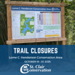 Picture of the Lorne C. Henderson Trail Sign with information regarding the trail closures underneath it.